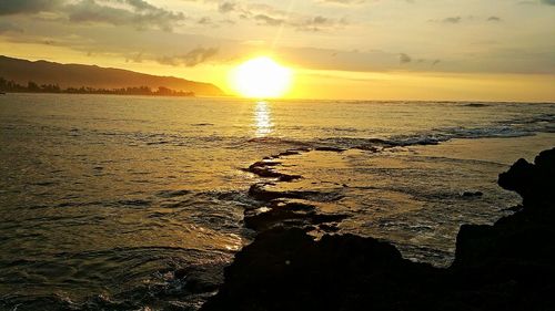 Scenic view of sea at sunset