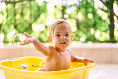 Portrait of cute baby boy in park