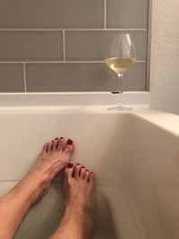 Low section of woman legs in bathroom at home