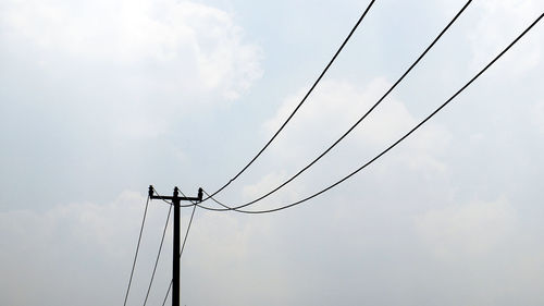 Low angle view of power line against sky