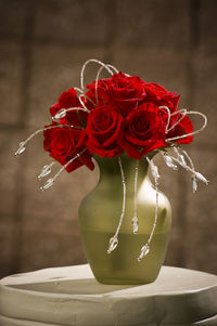 Close-up of red rose on table