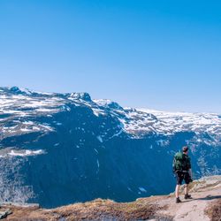 Man on mountain against clear blue sky