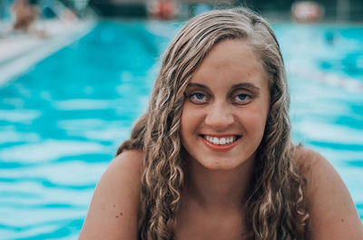 Portrait of smiling young woman in swimming in pool