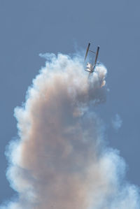 Low angle view of airshow against sky