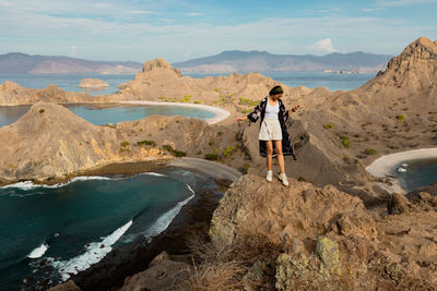 Man standing on mountain against sky