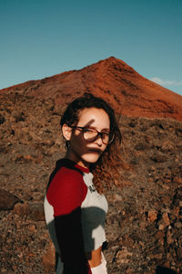 Full length of woman standing on land against sky