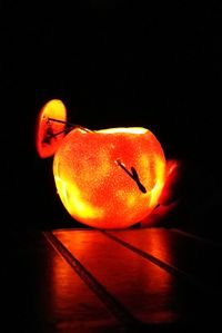 Close-up of orange fruit against black background