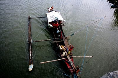 High angle view of fishing boat sailing over lake