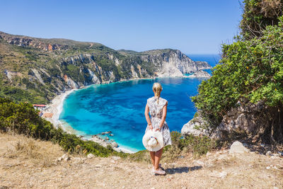 Rear view of woman looking at sea against sky