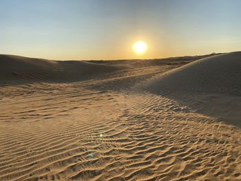 Scenic view of desert against sky during sunset