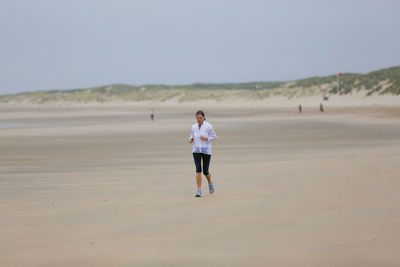 Full length of man walking on beach