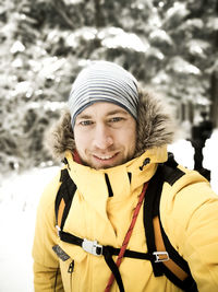 Portrait of smiling mid adult woman in snow