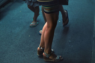 Low section of woman standing outdoors