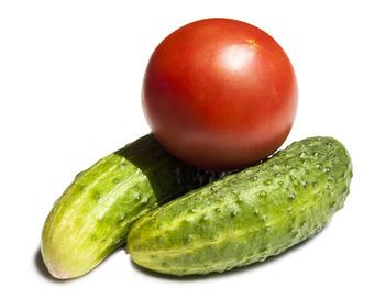 Close-up of tomatoes over white background