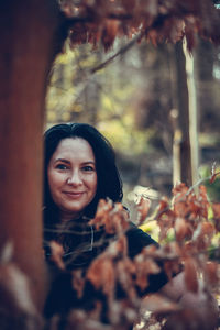 Portrait of young woman with leaves