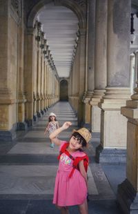 Portrait of girls standing in corridor of building