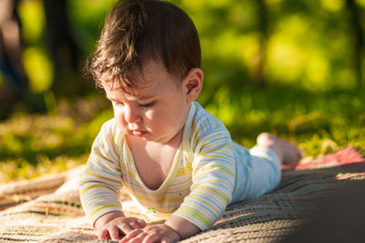 Cute baby boy on picnic blanket