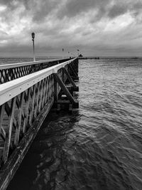 Pier over sea against sky