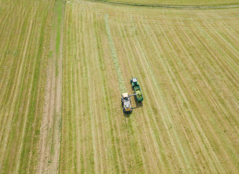 Aerial view of tractor on agricultural landscape during sunny day