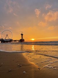 View of ferris wheel at sunset