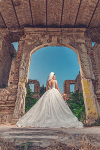 Rear view of woman standing against the sky