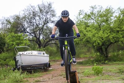 Man riding bicycle on plants