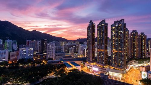 High angle view of illuminated buildings against sky at night