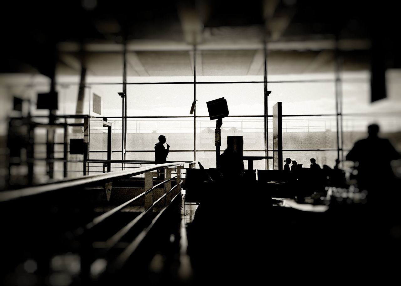 SILHOUETTE PEOPLE WALKING ON AIRPORT RUNWAY