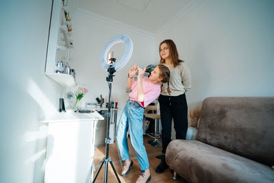 Mother and daughter record video use smartphone