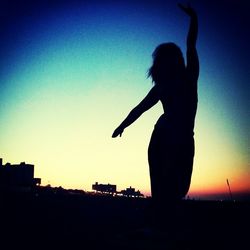 Silhouette of woman at sunset