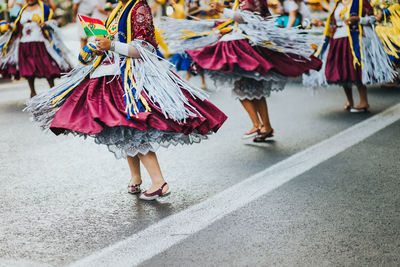Low section of women dancing on street in city
