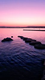 Scenic view of sea against romantic sky at sunset