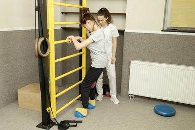 Rear view of boy walking on floor