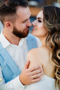 Close-up newlywed couple embracing outdoors