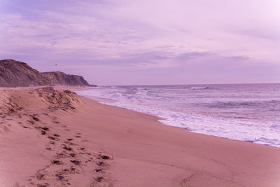 Scenic view of beach against sky during sunset