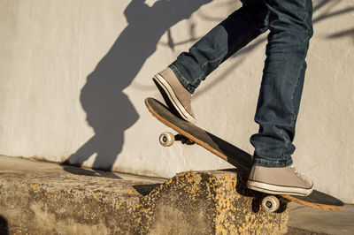 Low section of man skateboarding