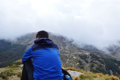 Rear view of man looking at mountains