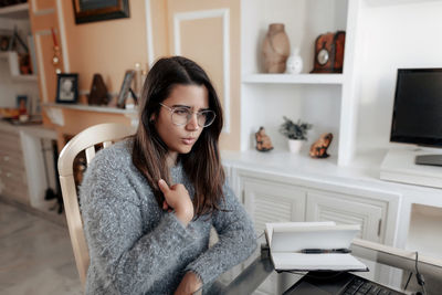 Portrait of woman sitting on table