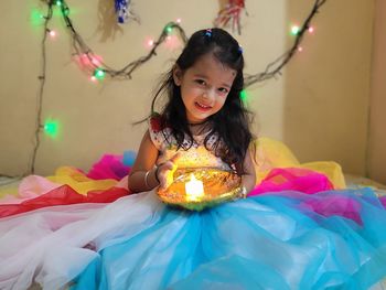 Portrait of happy girl in illuminated room