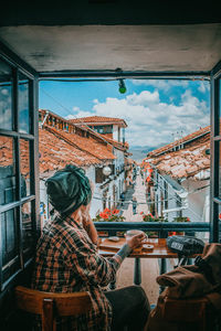 Rear view of people sitting at market stall