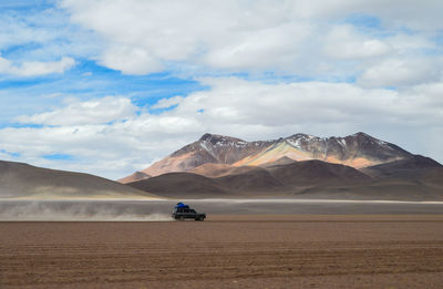 Scenic view of desert and mountains against sky