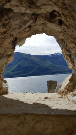 Mountains seen through hole in rock