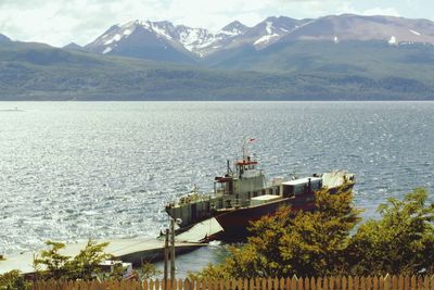 High angle view of sea and mountains against sky