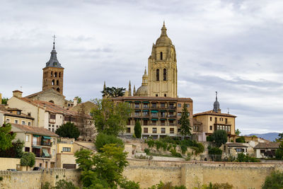 Buildings against cloudy sky