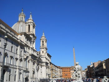 Low angle view of buildings against blue sky