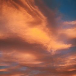 Low angle view of cloudy sky at sunset