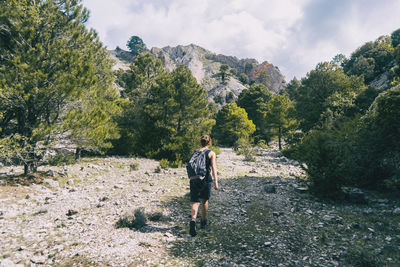 Woman hiking on a mountain path in catalonia on a cloudy summer day