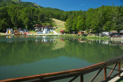 Scenic view of lake by trees and mountains