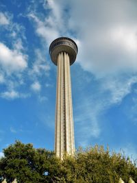 Low angle view of tower against cloudy sky