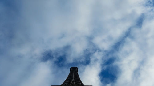 Low angle view of skyscraper against cloudy sky